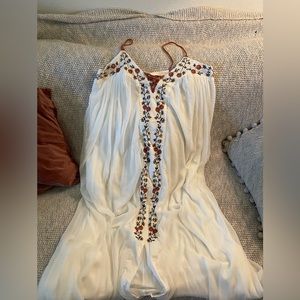 Long flowy white dress with brown woven straps